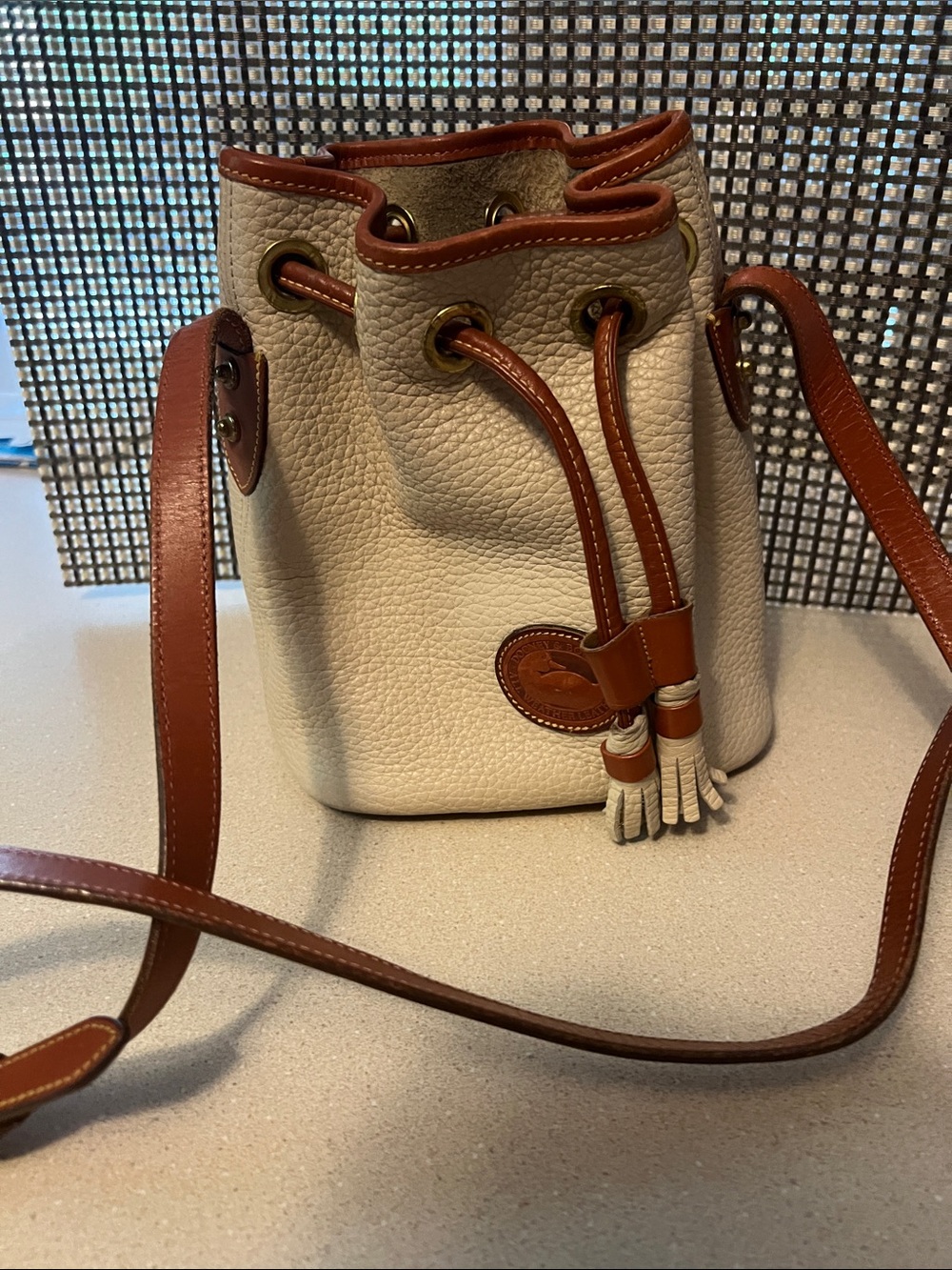 Dooney& Bourke Cream and Brown Leather Drawstring Bucket Bag